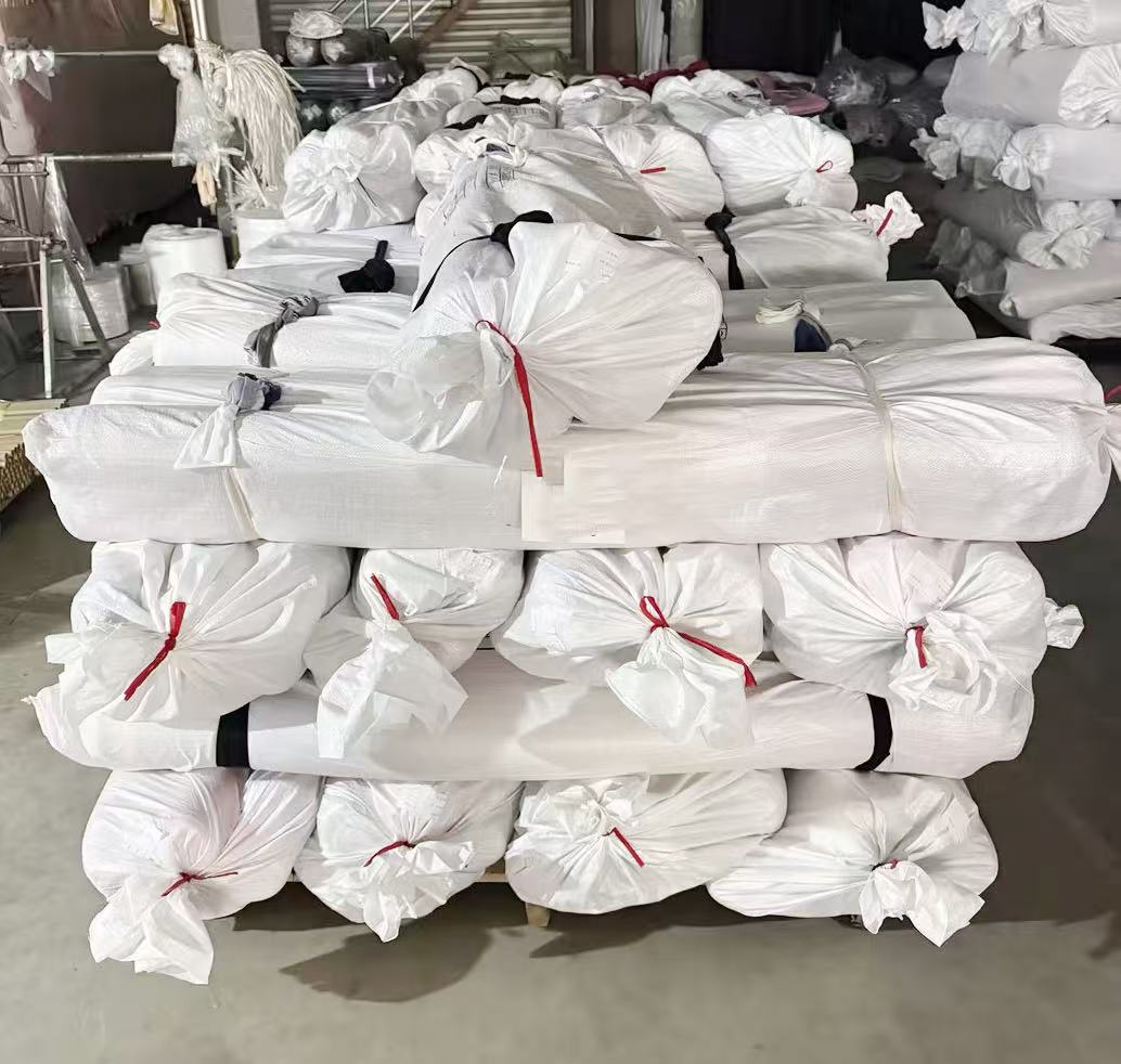 Rows of finished fabric rolls ready for shipping